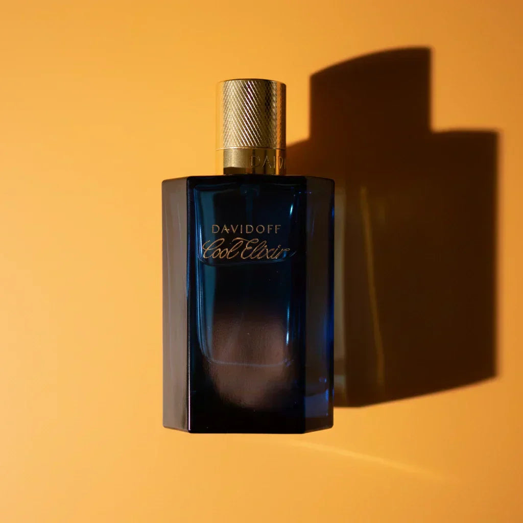 Blue Davidoff Cool Water Elixir perfume bottle with gold cap on a white background