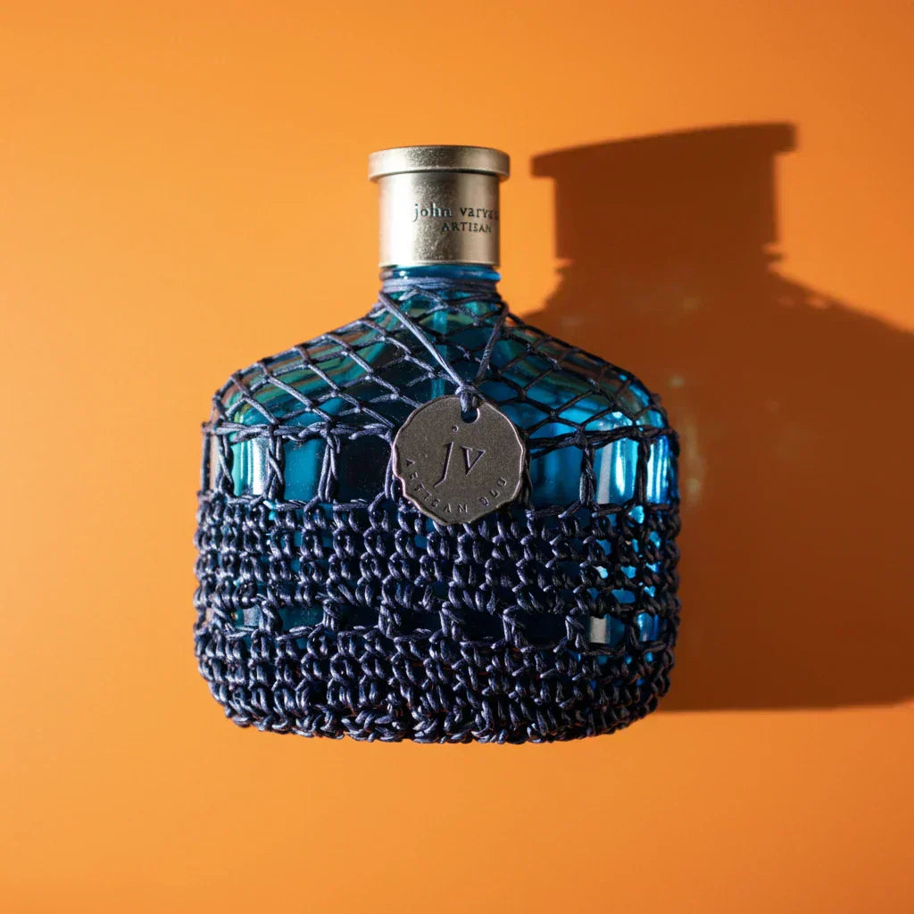 John Varvatos Artisan Blue fragrance bottle on a neutral background