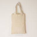 Beige tote bag on a light beige background