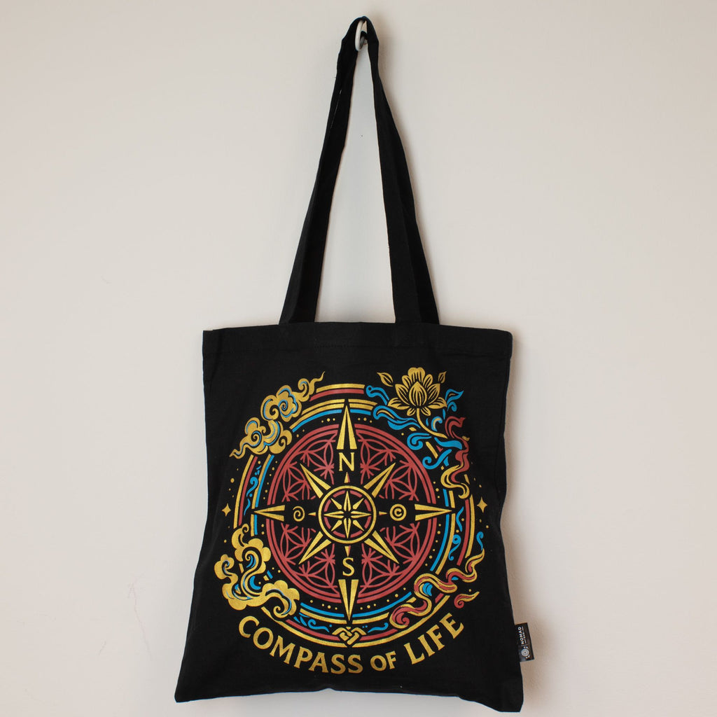 Black tote bag with 'Compass of Life' design on a white background