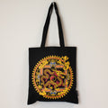 Black tote bag with a colorful dragon design on a white background