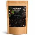 Kraft paper tea bag with 'Mandala Leaves' label and visible tea leaves inside.