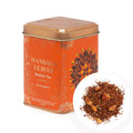 Orange tea canister labeled 'Mandala Leaves Rooibos Tea' with tea leaves on a white background