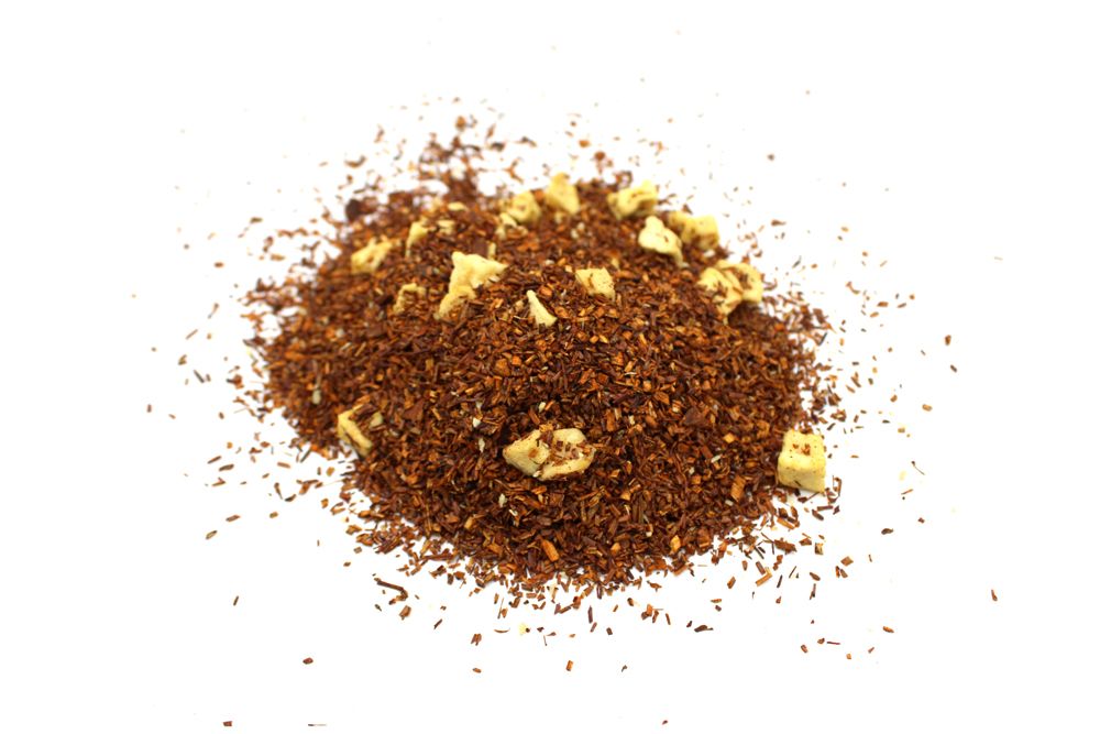 Pile of ground coffee with a few coffee beans on a white background