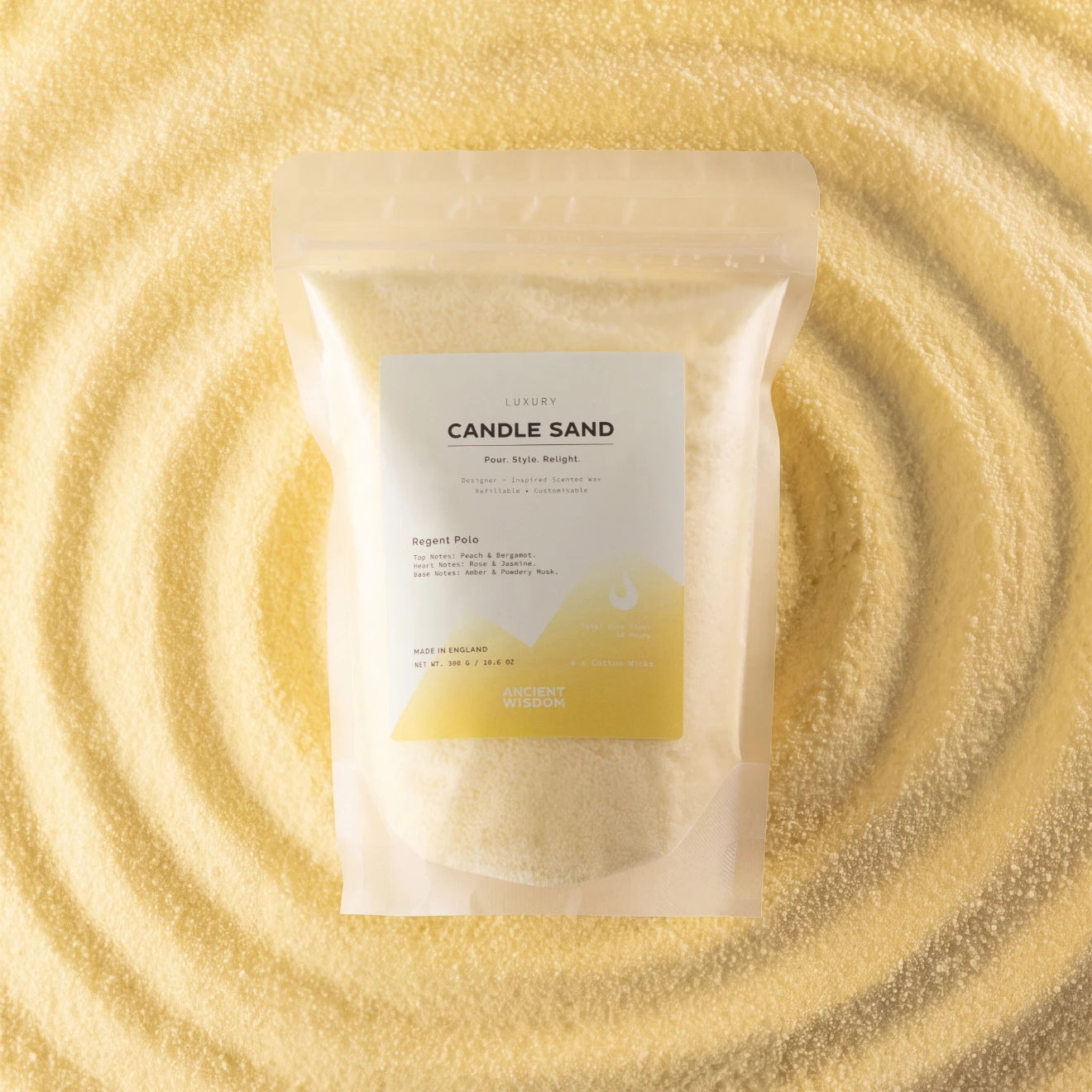 A stand-up pouch of Ancient Earths Candle Sand fragrance oil, filled with pale yellow wax, displayed on a background of matching textured wax swirls.