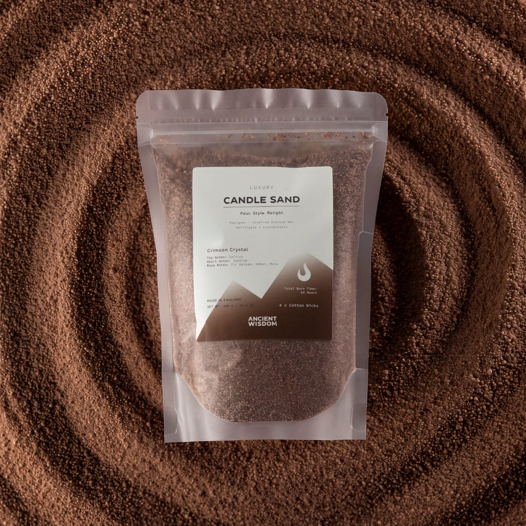A stand-up pouch of Ancient Wisdom Candle Sand (Flour Size Weight) placed on top of a circular arrangement of the same brown wax-like product, creating a textured background.