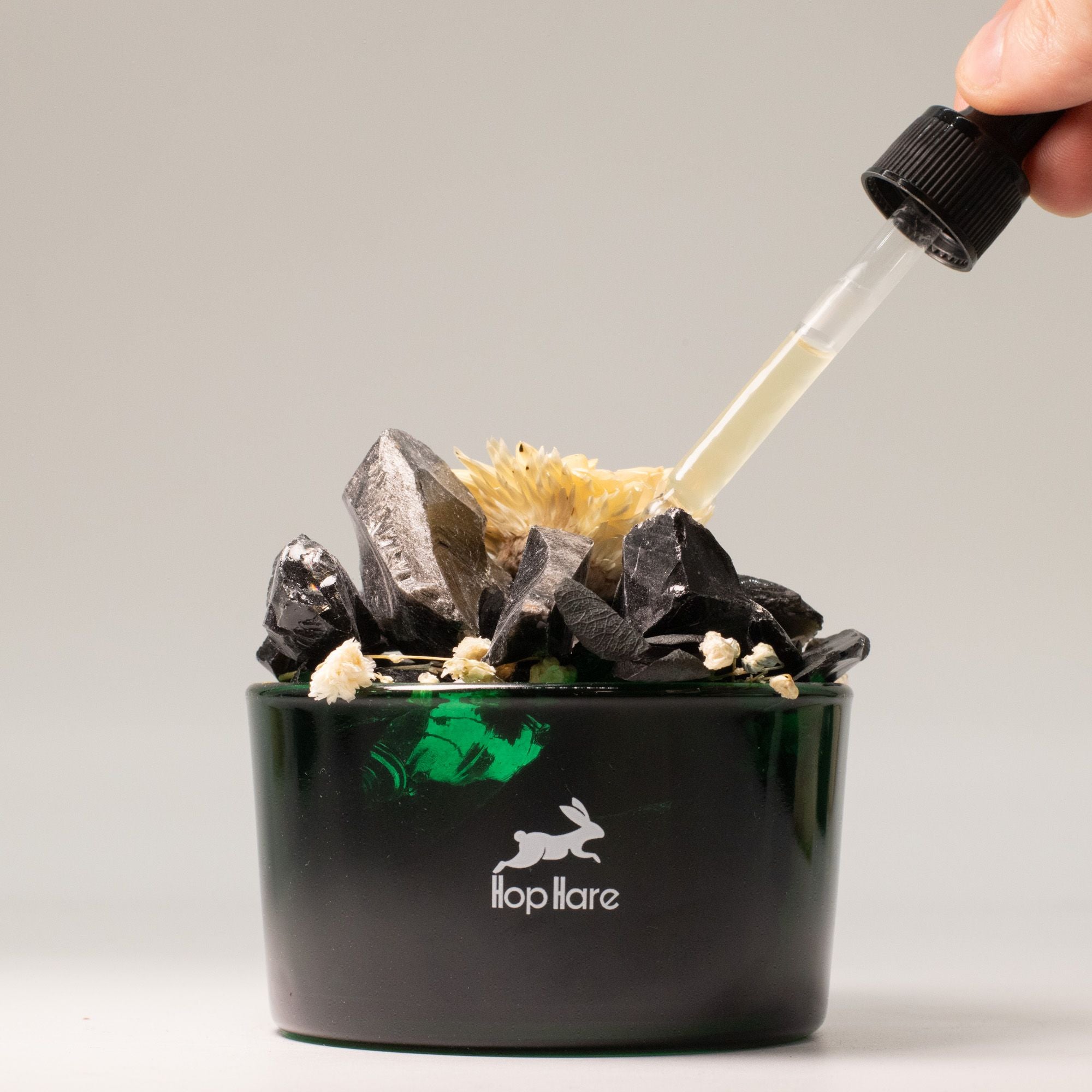 Black container with crystals and a dropper, featuring a brand logo on a gray background Hop Hare Diffusing Crystals & Floral Set - The King