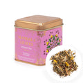 Tea tin labeled 'Mandala Leaves' with a small pile of tea leaves on a white background