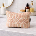 Patterned washcloth on a bathroom counter with toiletries in the background