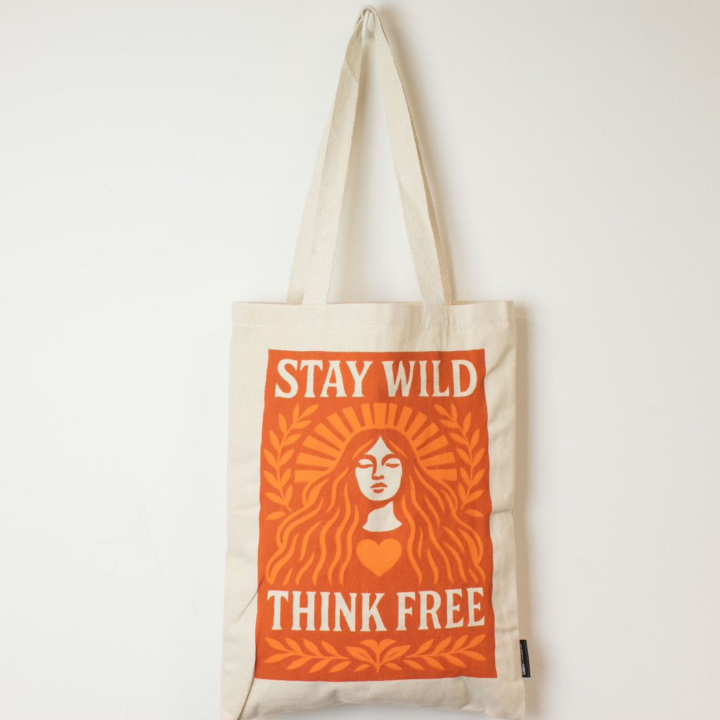 Tote bag with 'Stay Wild Think Free' design on a white background