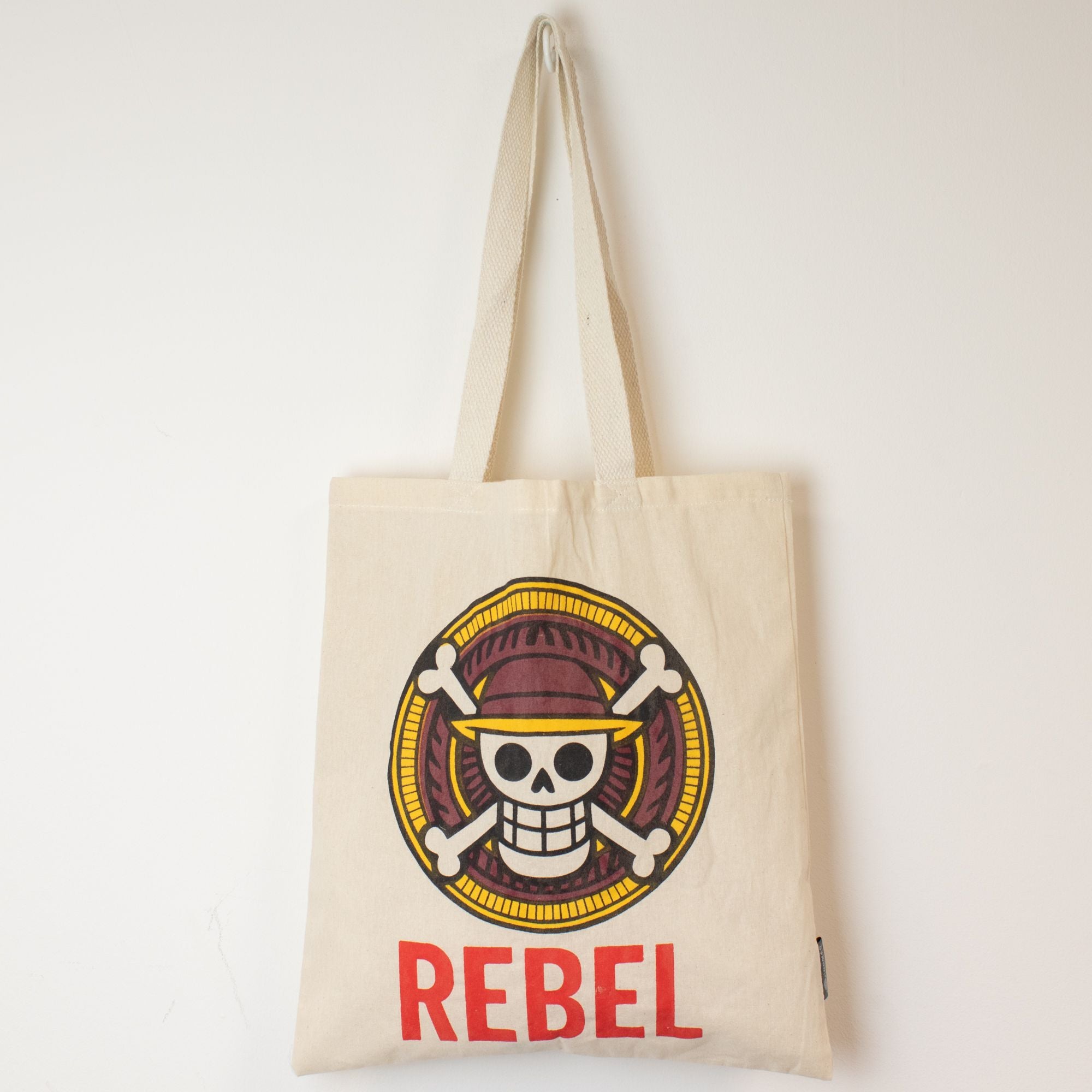 Tote bag with skull design and 'REBEL' text on a white background