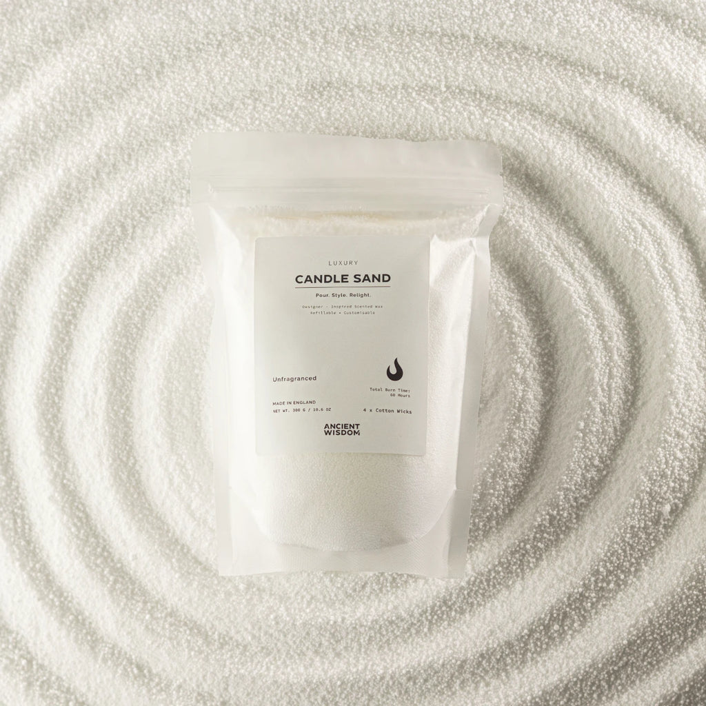 A white resealable pouch labeled 'CANDLE SAND' with 'ANCIENT MYSTERY' below, placed on a textured white surface with concentric circular ripples around it.