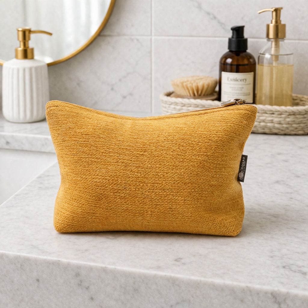 Yellow textured pouch on a bathroom counter with toiletries in the background