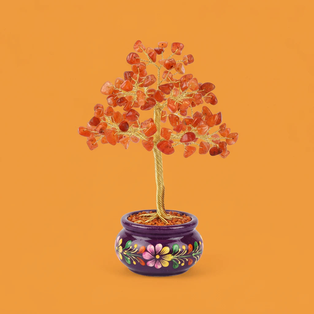 Decorative tree with red stones in a colorful pot on an orange background