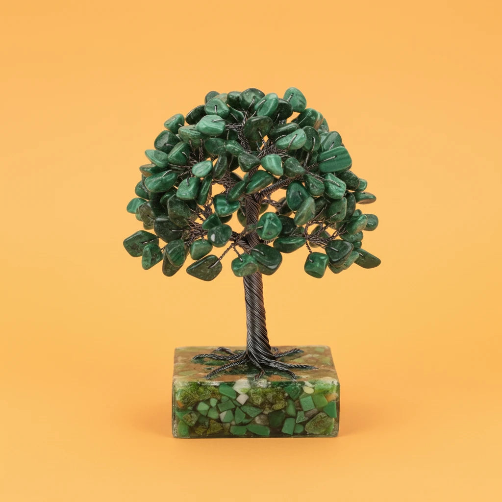 Decorative green tree sculpture on a stone base against an orange background