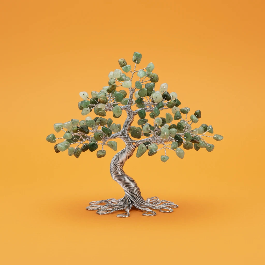 Decorative tree sculpture with green leaves and a silver trunk on an orange background