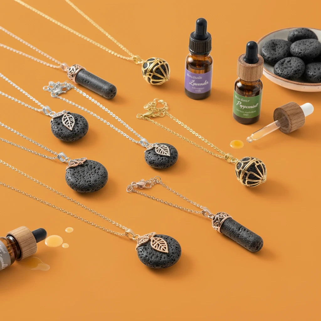 Necklaces with black stone pendants on an orange background, accompanied by essential oil bottles and droppers.